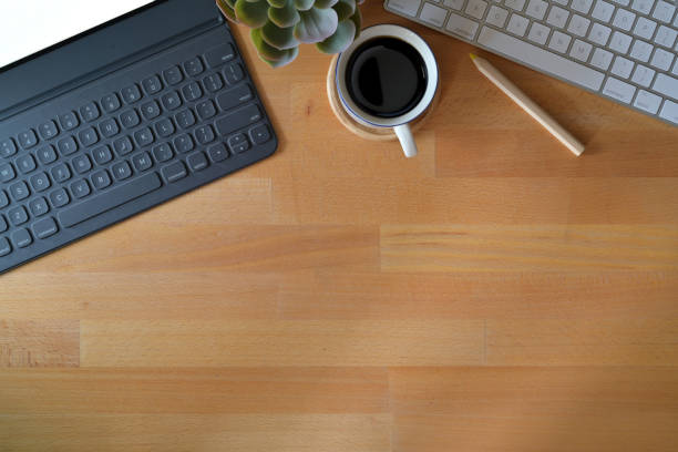 istock Top view wooden office desk workspace table with tablet, office supplies and copy space 1084345674