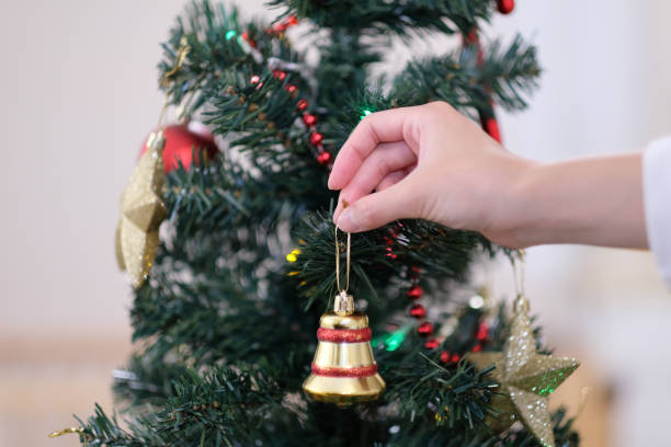 istock Closeup of hand decorating Christmas tree 1084349112