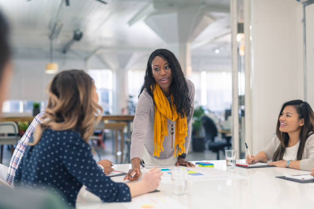 istock Female CEO leads a team meeting 1084349426