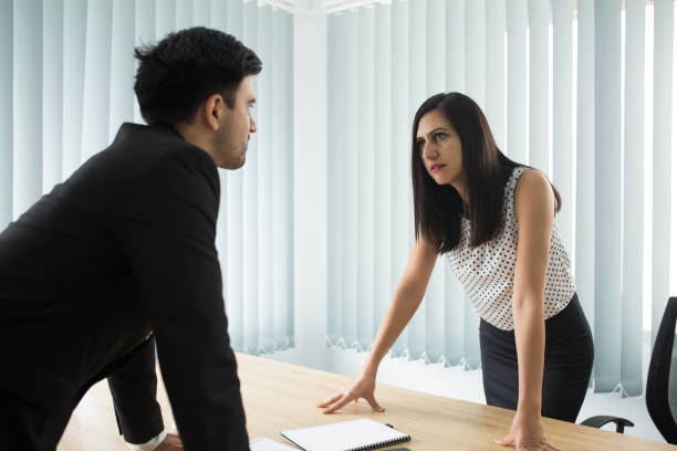 istock Confrontation between male and female partners in boardroom 1084351010