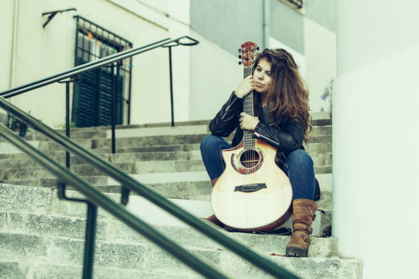 istock Content dreamy street performer having break 1084356620