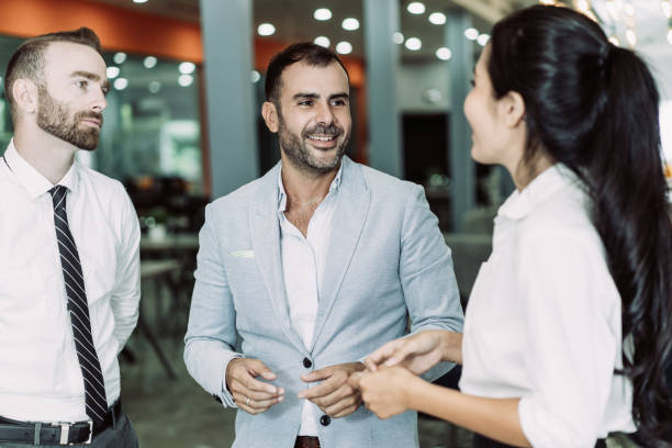 istock Three positive business people chatting in office lobby 1084359988