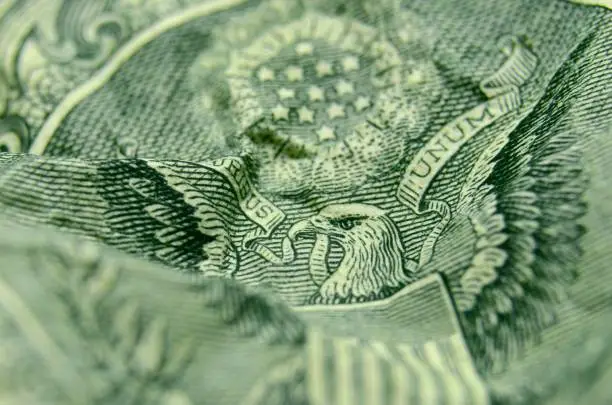 Photo of Selective focus on the eagle's face from the reverse of the US 1 dollar bill.