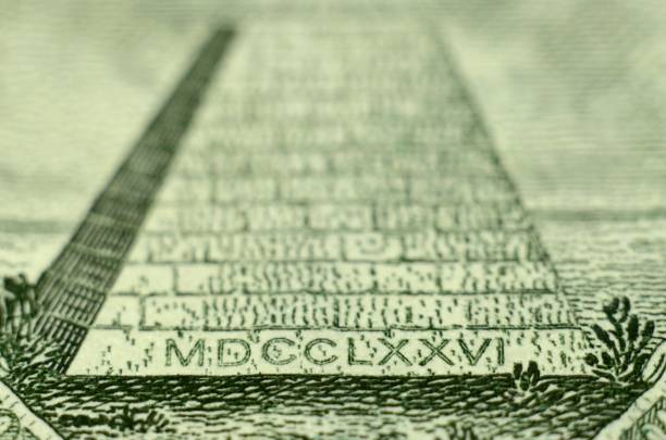 extreme close up the pyramid on the back of the american one dollar bill, featuring 1776 in roman numerals. - close up one dollar bill history finance imagens e fotografias de stock