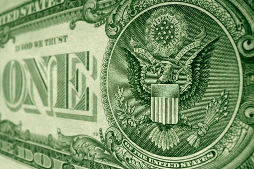 Shot of the US coat of arms on the back of the American dollar bill faeturing the eagle from the great seal.