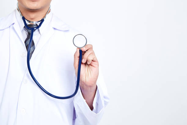 istock Doctor holding stethoscope on white background. Asian male model 1084367152