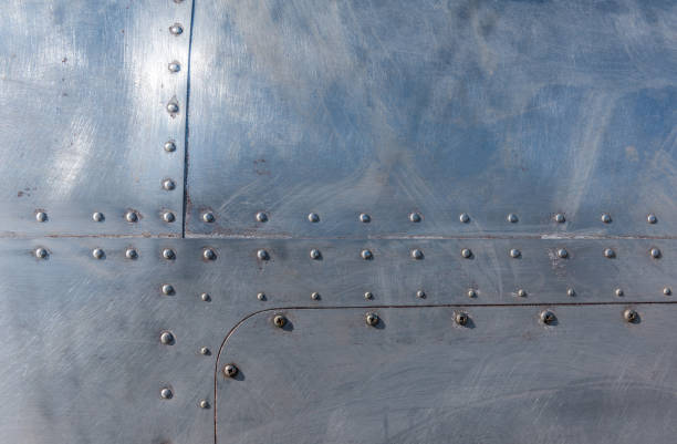 Aluminum with rivets Weathered aluminum airplane fuselage with rivets background. fuselage stock pictures, royalty-free photos & images