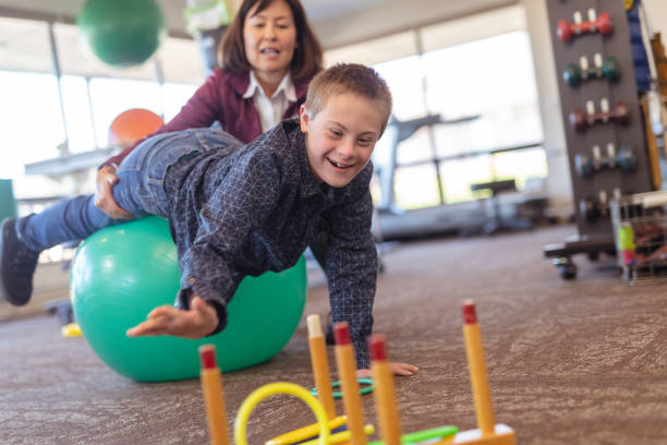 istock A boy does workouts with an occupational therapist at a physiotherapy clinic 1084372386