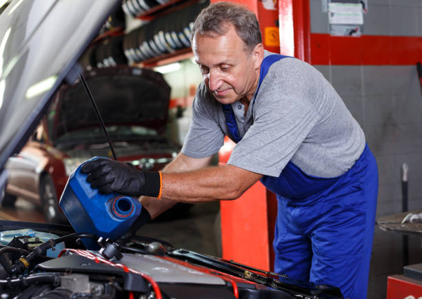 istock Mechanician changing motor oil 1084382704