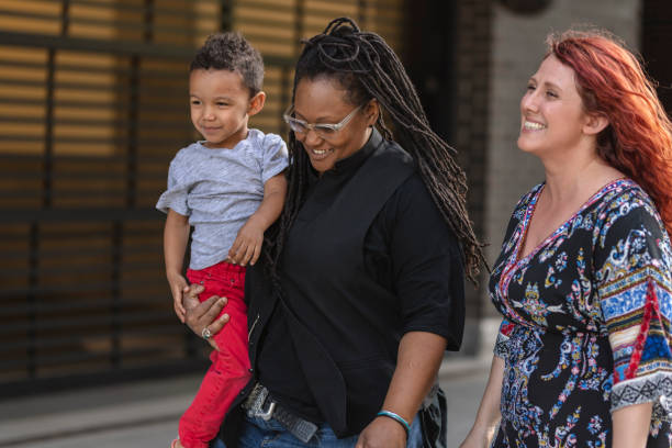 istock Female couple walking with their son 1084383578