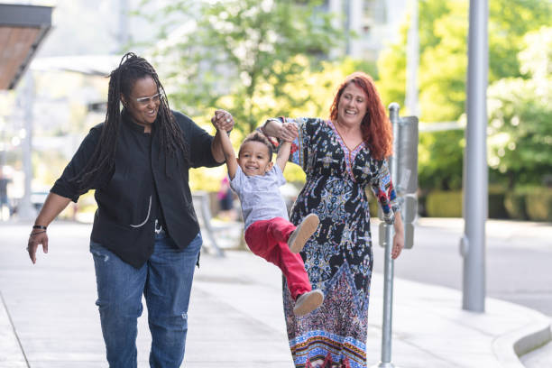 istock Female couple walking with their son 1084383580