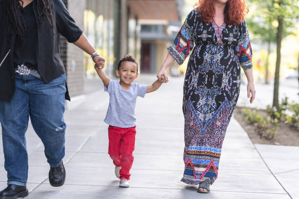 istock Female couple walking with their son 1084383586
