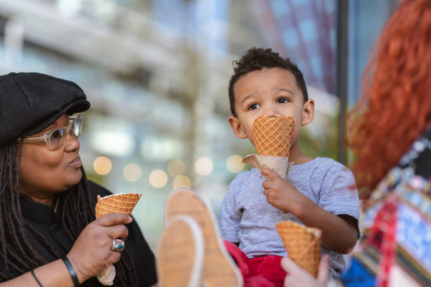 istock Two moms eat ice cream with their three-year old son 1084383598