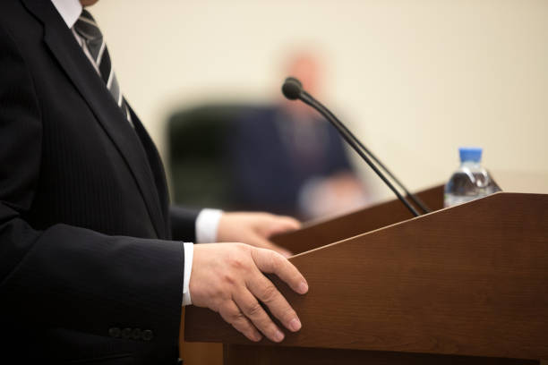 istock the man hold microphone on the stage. 1084386608