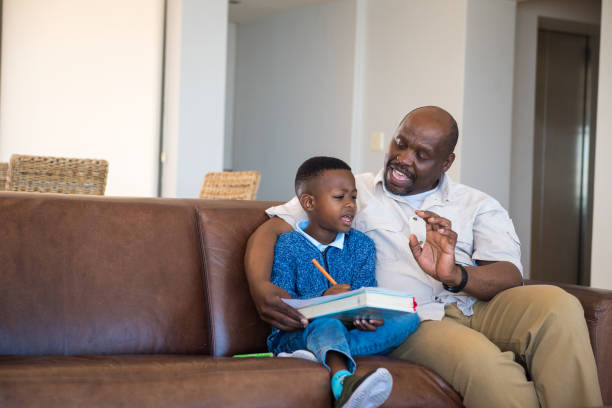 istock Granfather helping grandson with homework 1084387888