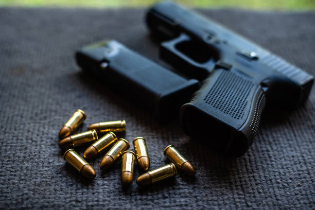 istock bullets and gun on black velvet desk 1084393352