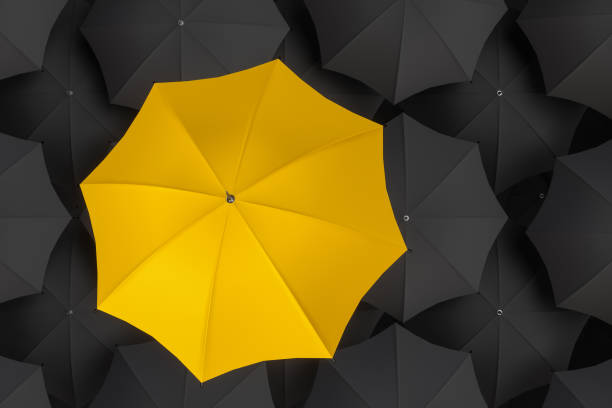 istock Yellow Umbrella - Stand out from the crowd 1084393486