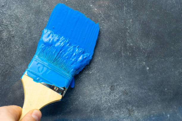 istock Brush for paints on a beautiful blue background. 1084400018