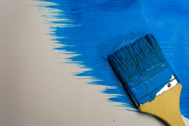 istock Brush for paints on a beautiful blue background. 1084400376