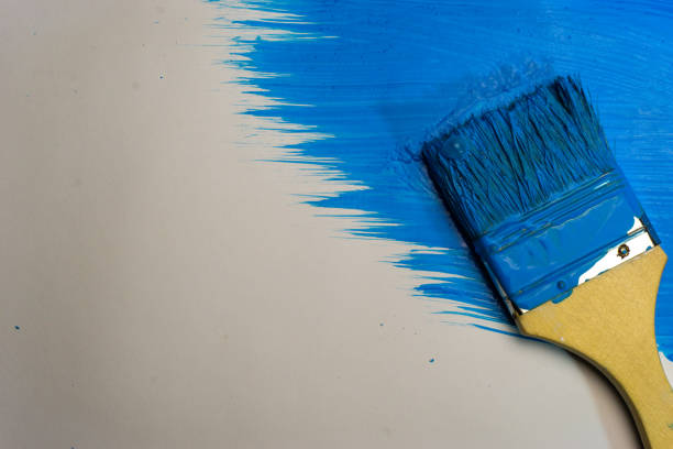 istock Brush for paints on a beautiful blue background. 1084401724