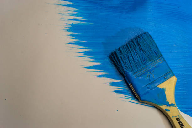 istock Brush for paints on a beautiful blue background. 1084401878