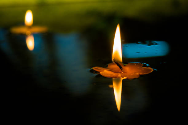 istock Yellow Flower Candle burning floating in water. 1084404134