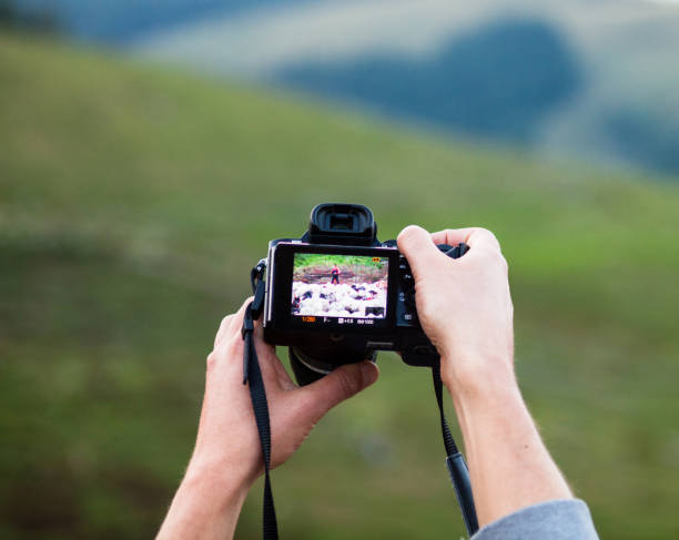 istock Hands holding the digital photo camera 1084409060