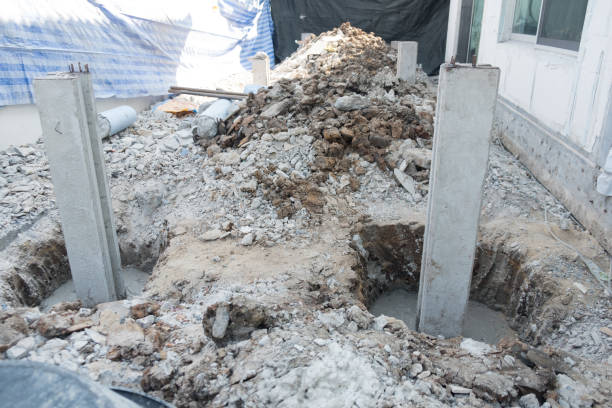 Concrete piles foundation under ground for a new building on construction site.