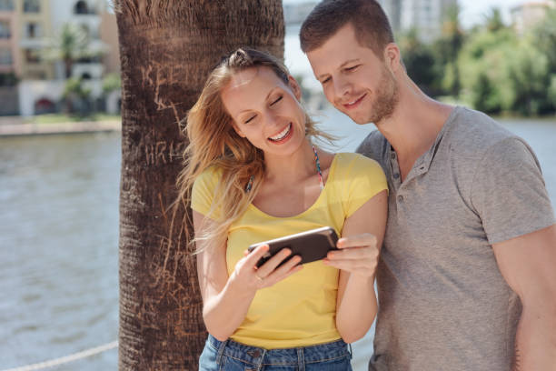 istock Young couple looking at a mobile phone together 1084413418