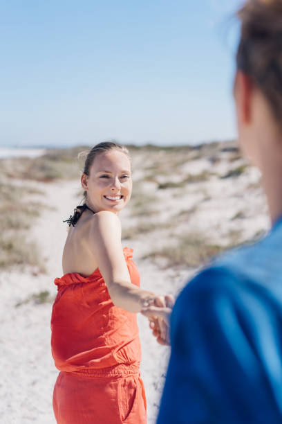 istock Laughing young woman looking back at her boyfriend 1084415230
