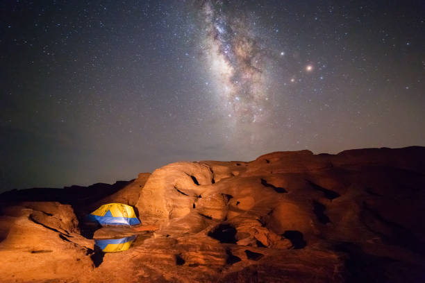 istock Camping tent under milky way at night 1084416246