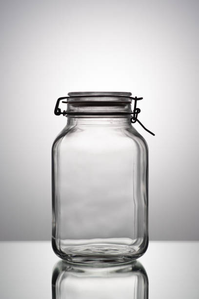 istock Still life of glasses on gray gradient background: empty jar 1084428204
