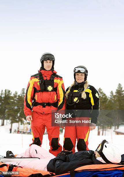 Rescue Team With Skier Stock Photo - Download Image Now - Ski Patrol, Mountain, Rescue
