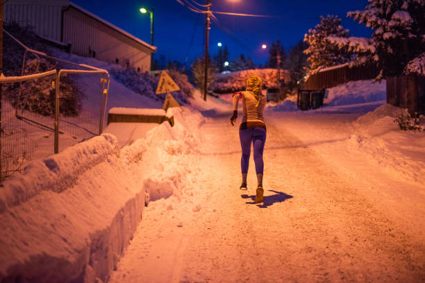 istock Women running at snow night. 1084430566