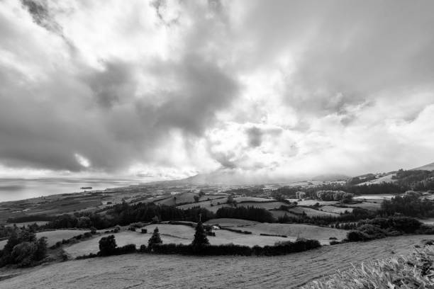 istock Black and White view of Pastures and Clouds 1084440076