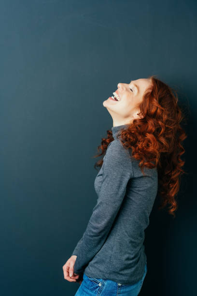 istock Young red-haired cheerful woman laughing 1084440550