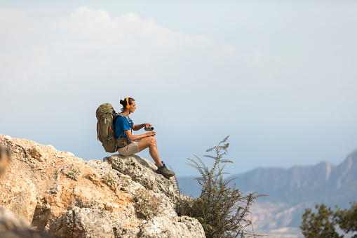Climber resting on a mountaintop.