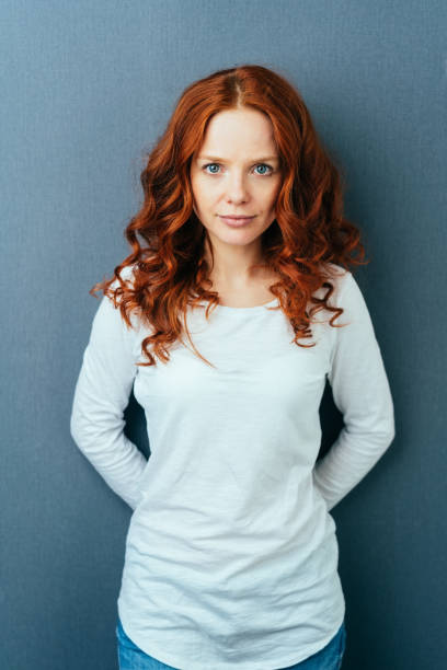 istock Calm quiet young woman staring at the camera 1084441068