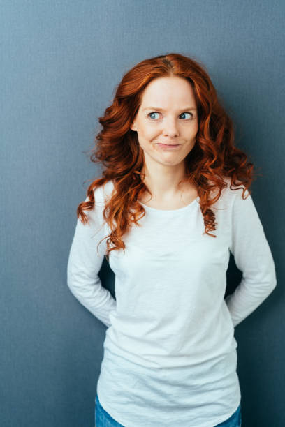 istock Pensive playful young woman looking aside 1084441072