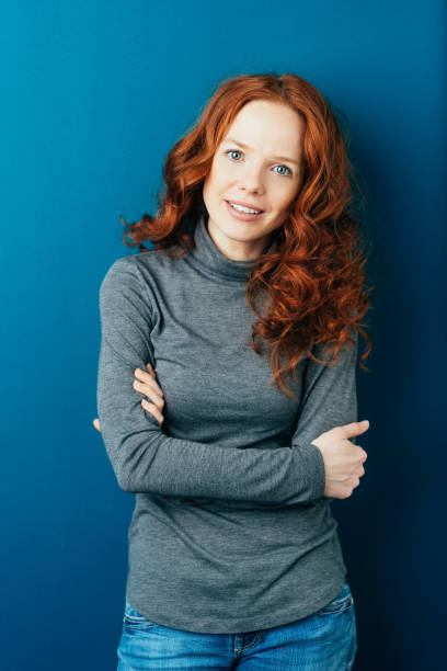 istock Serious interested young redhead woman in jeans 1084442448