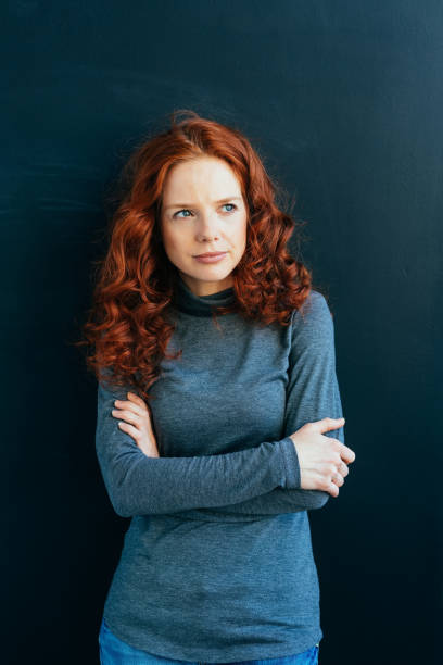 istock Thoughtful young redhead woman thinking deeply 1084442452