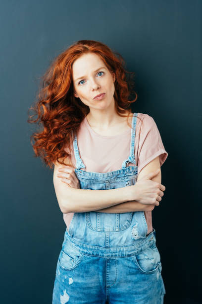 istock Intense young woman in trendy dungarees 1084443876