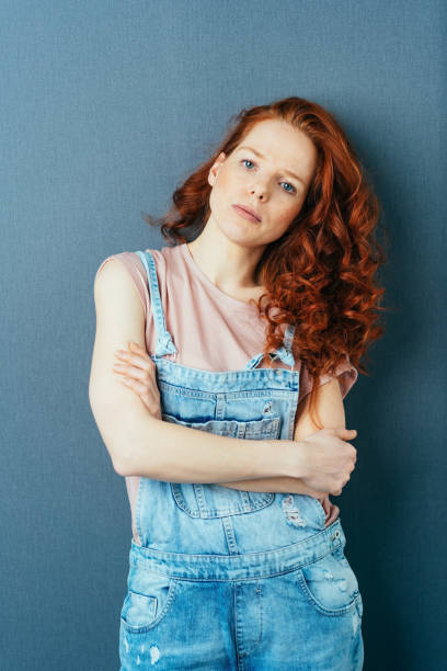 istock Serious calm young redhead woman with folded arms 1084445434