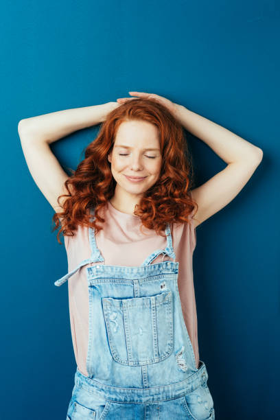 istock Serene young woman stretching with closed eyes 1084448624