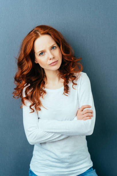 istock Serious young woman gazing intently at the camera 1084448896