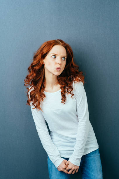 istock Angry young woman pursing up her lips 1084448898