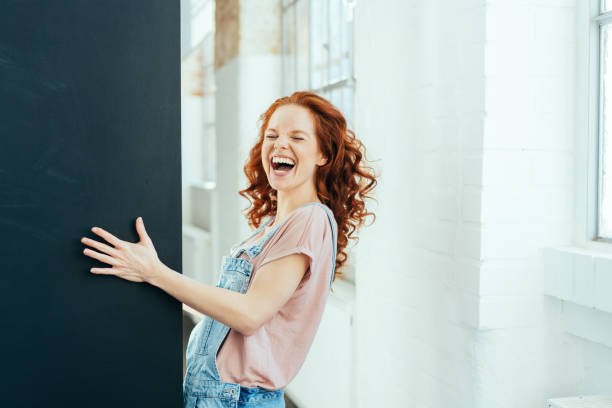 Laughing vivacious joyful young redhead woman