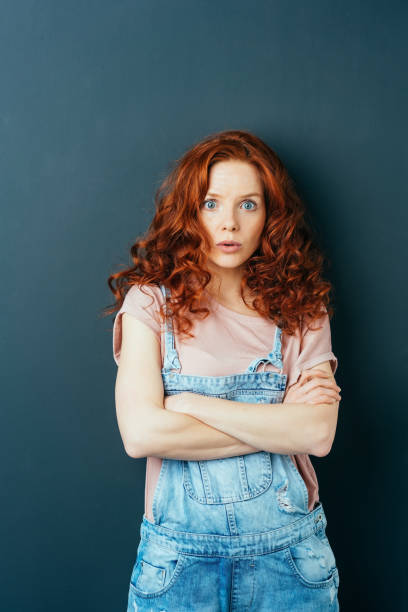 istock Astonished or surprised woman staring at camera 1084451386