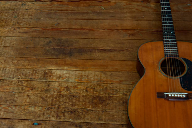 istock Vintage Acoustic Guitar on hardwood Floor. 1084451990