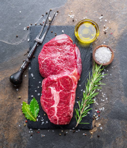 istock Raw  Rib eye steak or beef steak with herbs and spices. 1084453216